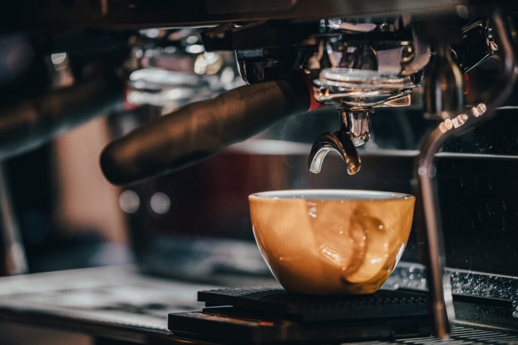 caffee machine and a cup with espresso shot